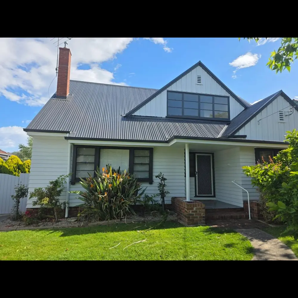Weatherboard character home exterior in Torquay finished in crisp white with charcoal window frames and trims