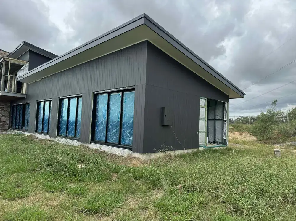 Side elevation of a charcoal-rendered home after an exterior repaint