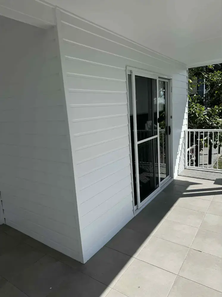 Freshly painted white cladding and ceiling under a covered verandah