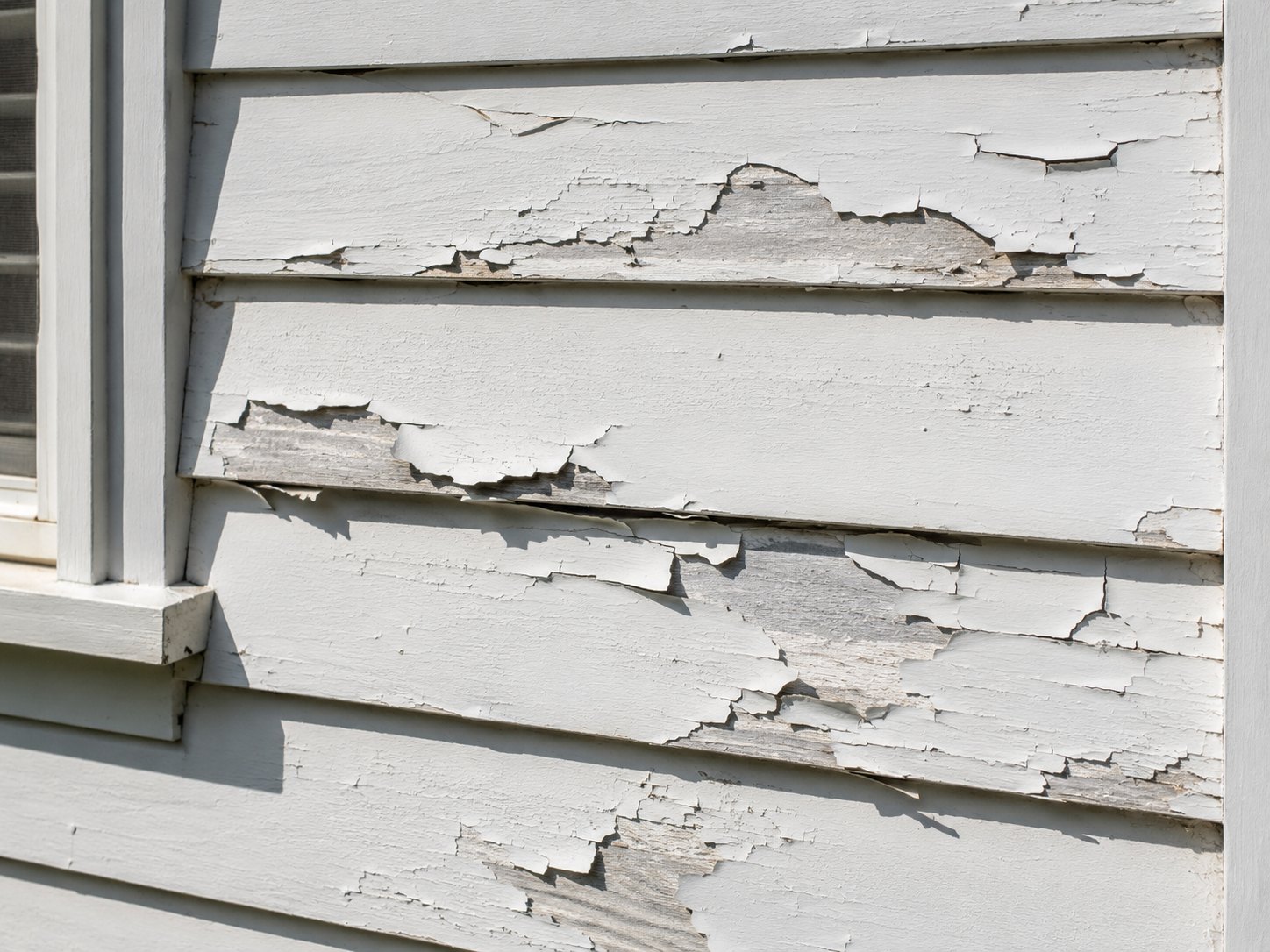 Peeling and cracked paint on a weatherboard wall showing a common painting problem in Geelong